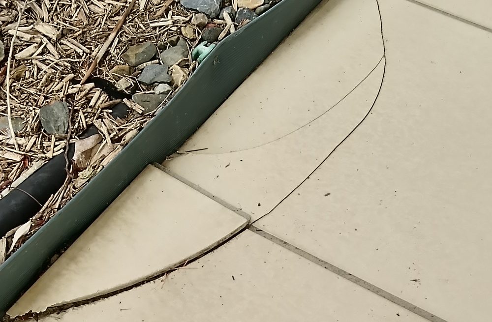 Cracked outdoor floor tiles before repair, Cairns